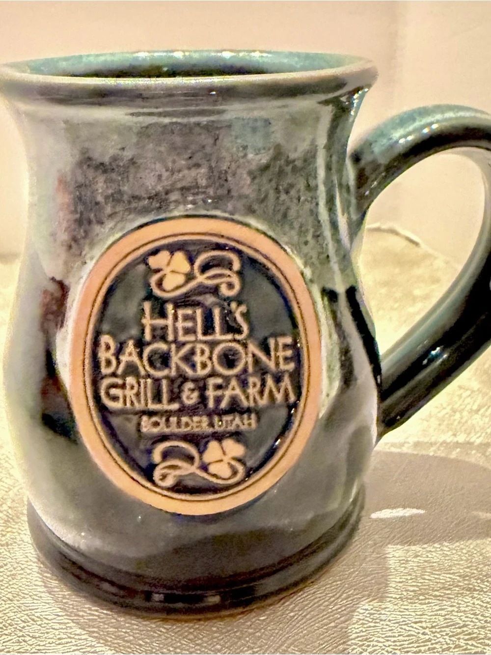Hell’s Backbone Grill & Farm Deneen Pottery Bolder Utha Dark Green Ceramic Mug.